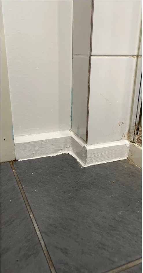 Repaired and repainted bathroom tile area